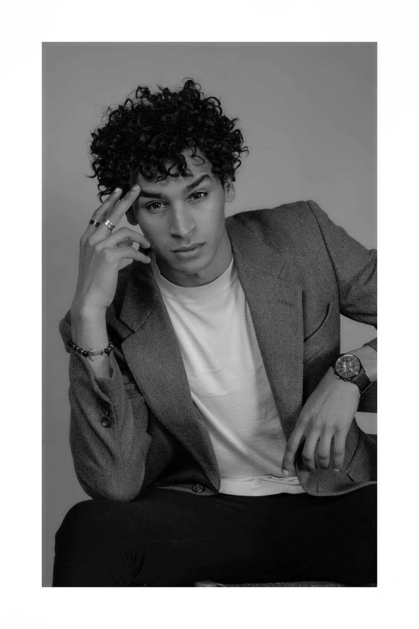 Achraf Taoussi — black and white studio portrait in blazer