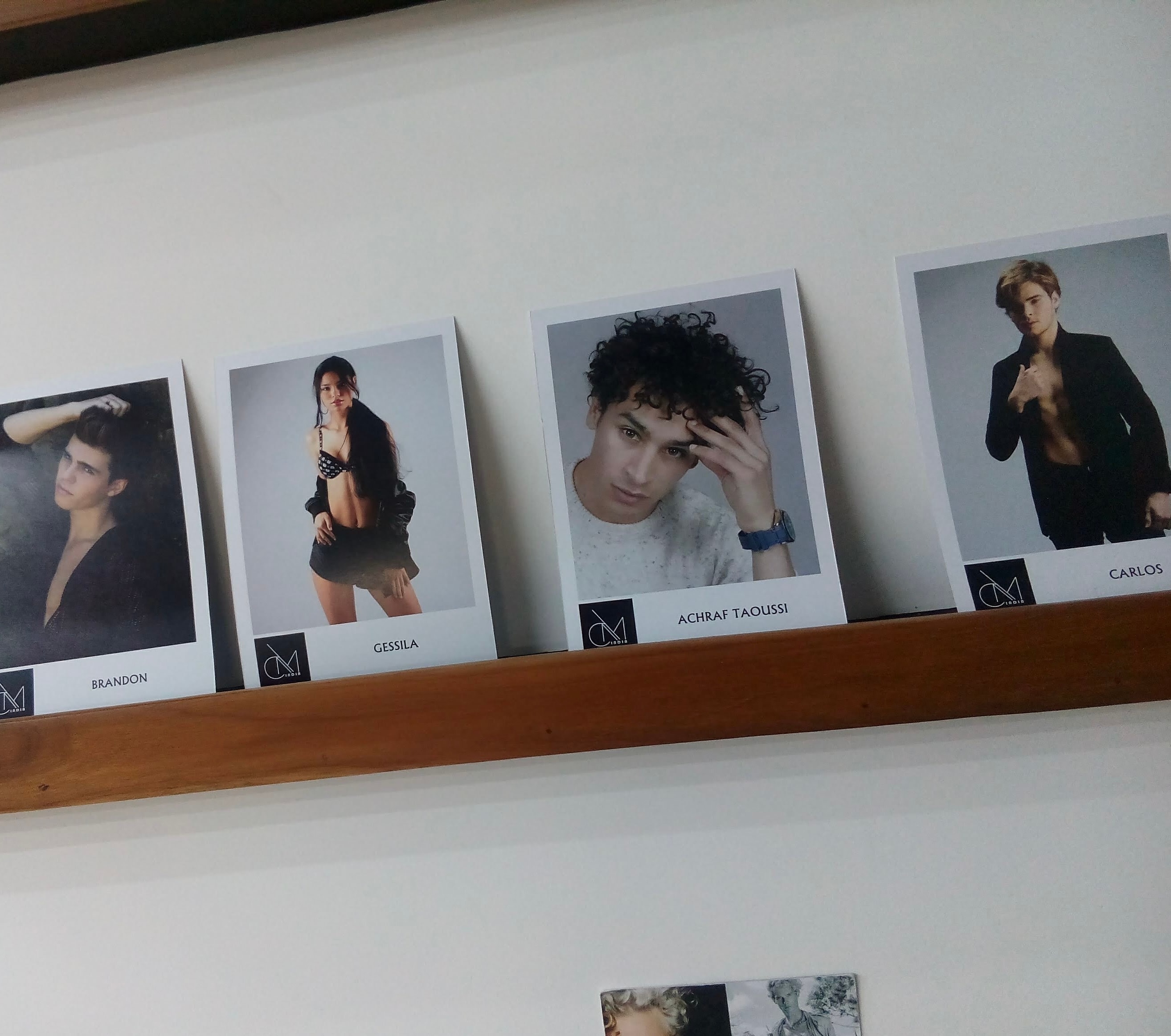 Achraf Taoussi — agency composite cards on shelf