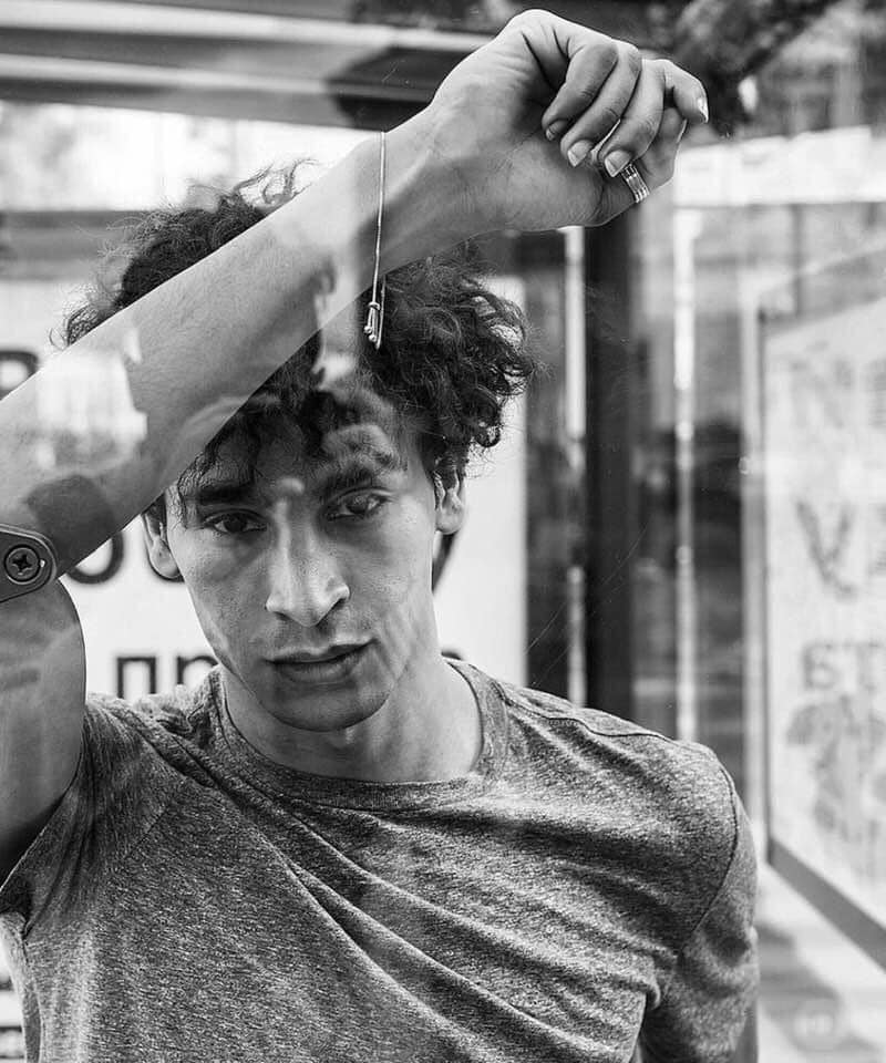 Achraf Taoussi — arm raised black and white
