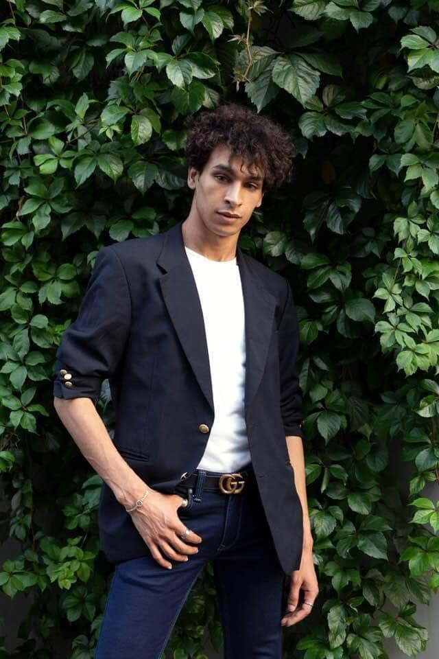 Achraf Taoussi — black blazer green foliage