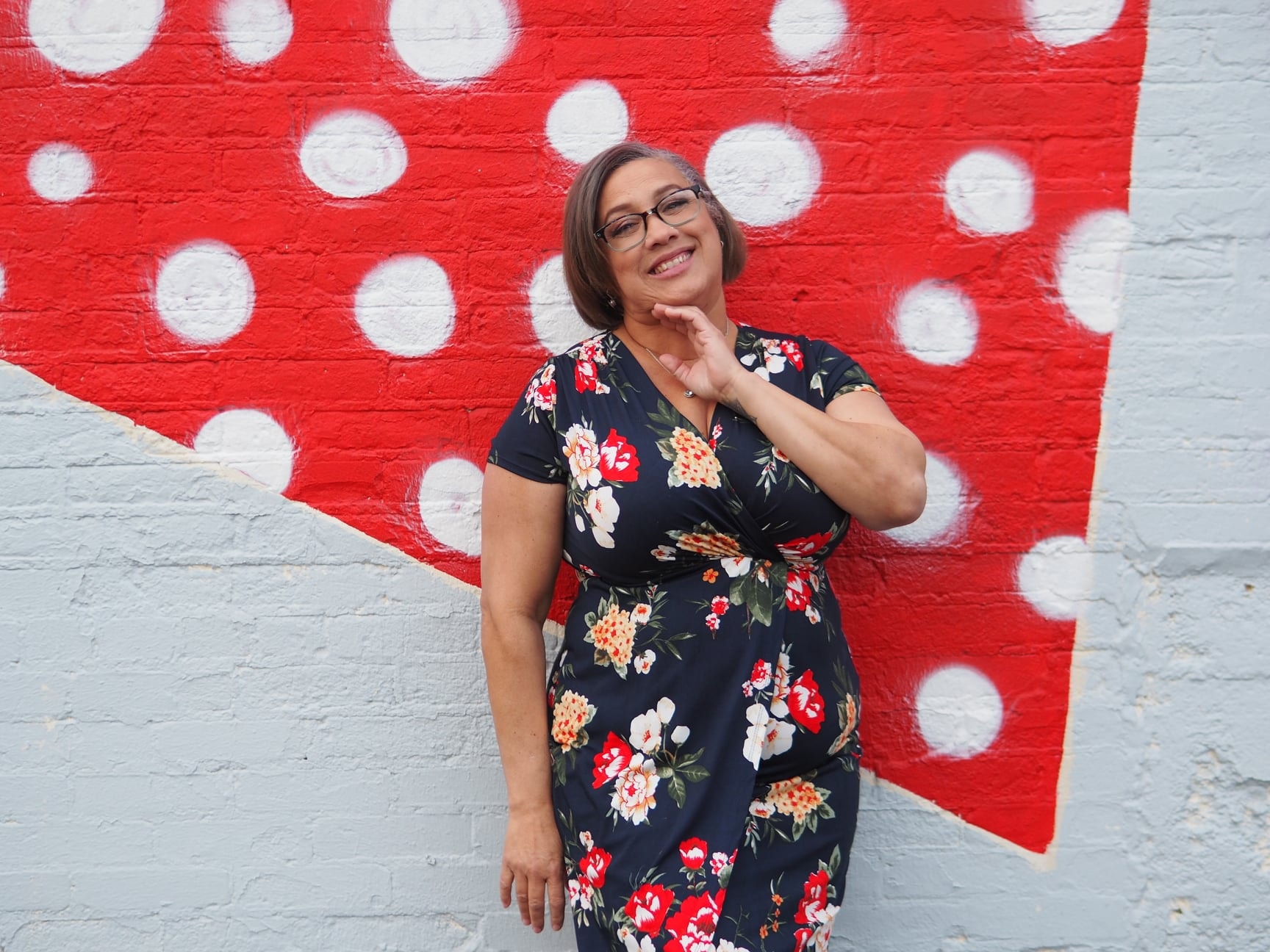 Iris against red and white polka-dot mural