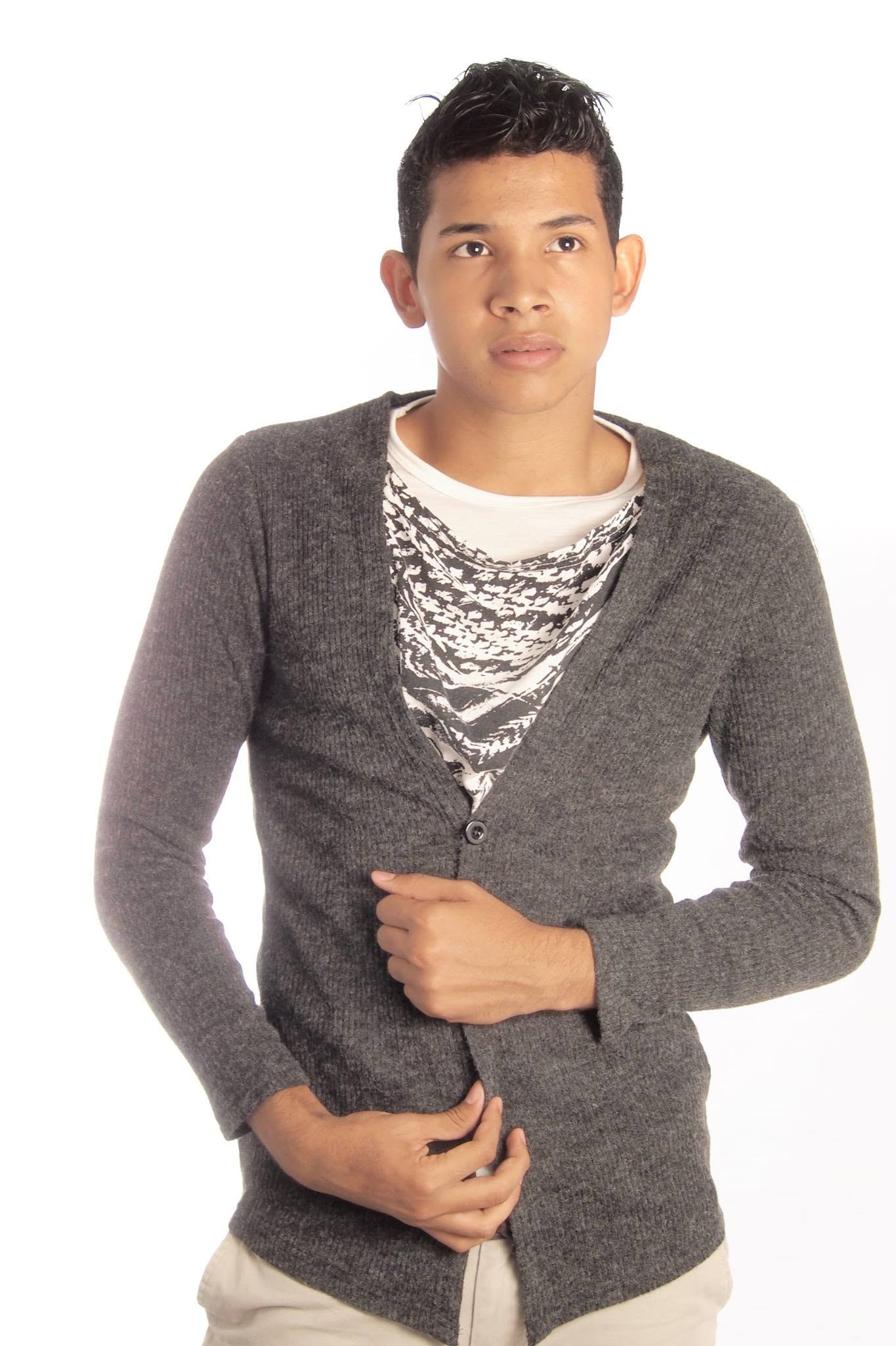 Joel Orasma Martinez — studio portrait in grey cardigan